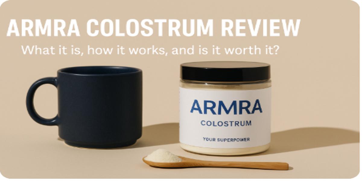 Armra Colostrum jar beside a ceramic mug and wooden scoop of powder, with text overlay reading “Armra Colostrum Review: What it is, how it works, and is it worth it?”
