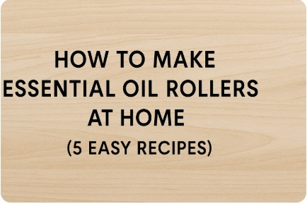 "Wood-textured digital banner with bold black title text that reads: How to Make Essential Oil Rollers at Home (5 Easy Recipes)